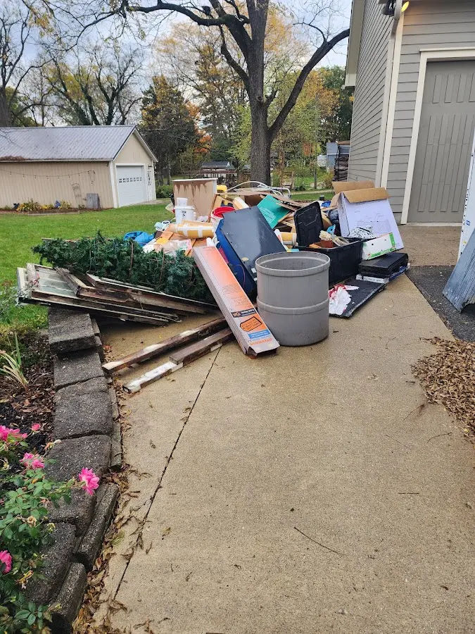 Dumpster being loaded with debris for Commercial Dumpster Rental in Jasper